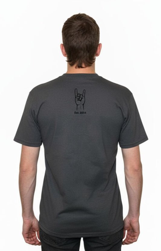 Person wearing a dark gray t-shirt with a design on the back, standing against a white background